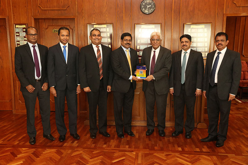 Commercial Bank’s Managing Director Mr S. Renganathan (Centre) and Central Bank Governor Dr Indrajit Coomaraswamy at the signing of the agreement in the presence of (from left) Commercial Bank’s Manager - Card Centre Mr Seevali Wickramasinghe, Head of Card Centre Mr Thusitha Suraweera, Deputy General Manager – Marketing Mr Hasrath Munasinghe, Central Bank Assistant Governor Mr Ananda Jayalath and Central Bank Director - Payments & Settlements Mr Dharmasri Kumaratunge.