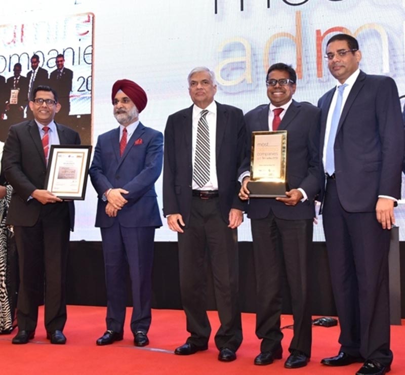 HNB Chief Operating Officer, Dilshan Rodrigo (second from right) and Deputy General Manager- Risk /Chief Risk Officer / Chief Information Security Officer, Damith Pallewatte (extreme left) with the award presented by Hon. Prime Minister Ranil Wickremesinghe together with Indian High Commissioner, Taranjit Singh Sandhu and HNB Chairman/ ICCSL Chairman, Dinesh Weerakkody,