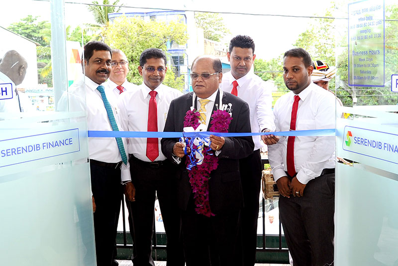 Commercial Bank and Serendib Finance Chairman Mr Dharma Dheerasinghe cuts the ribbon to declare open the relocated Serendib Finance Dambulla Branch in the presence of the Bank’s Managing Director and CEO Mr S. Renganathan (extreme left), Managing Director and CEO of Serendib Finance Mr Upul Dissanayake (3rd from left) and representatives of the senior management of Serendib Finance.
