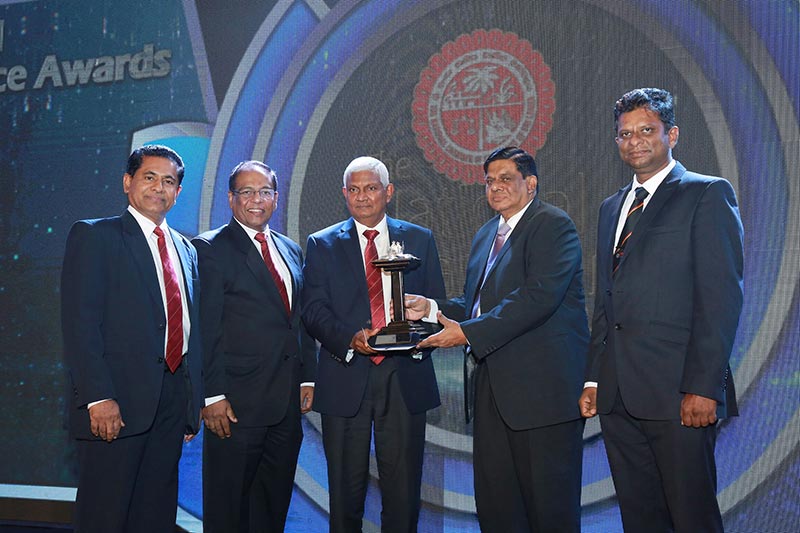 Ceylinco Life Chairman Mr R. Renganathan (Centre) and Directors Mr Devaan Cooray (second left) and Ranga Abeynayake (extreme left) with one of the National Business Excellence awards presented to the Company
