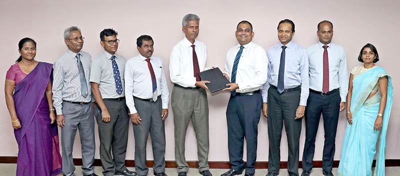 Commercial Bank Deputy General Manager – Marketing Mr Hasrath Munasinghe (4th from right) and Ceylon Electricity Board (CEB) Additional General Manager – Corporate Strategy Dr Eng D. C. R. Abeysekera exchange the agreement in the presence of representatives of the two institutions.