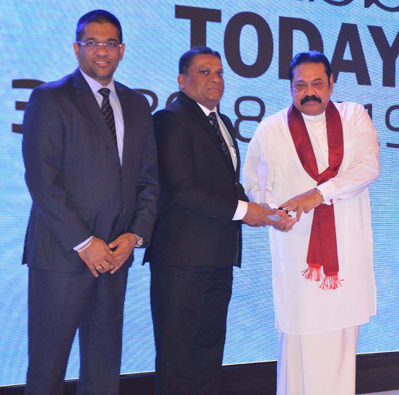Mahesh Nanayakkara, Managing Director and CEO of CDB together with Damith Tennakoon, Director, Deputy CEO and CFO of CDB, receiving the prestigious accolade from the Honourable Prime Minister Mahinda Rajapaksa.