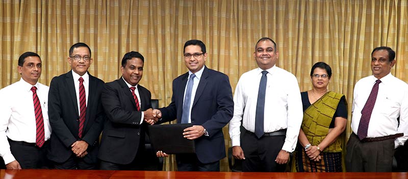 Commercial Bank’s Chief Operating Officer Mr  Sanath Manatunge (Centre) and Toyota Lanka (Pvt) Ltd. Director /Chief Operating Officer Mr Manohara Atukorala (3rd from left) exchange the agreement in the presence of (From left) Toyota Lanka (Pvt) Ltd. Head/Manager Shared Sales Support Mr Anil Algama, General Manager - New Vehicle Sales Department Mr Udaya Francis, Commercial Bank Deputy General Manager – Marketing Mr Hasrath Munasinghe, Deputy General Manager – Personal Banking Mrs Sandra Walgama and Deputy General Manager - Corporate Banking Mr Naveen Sooriyarachchi.