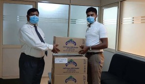 Laksiri Amaratunga, General Manager Pelwatte Dairy Industries  handing over a con-signment of milk powder to the AG office in Buttala.