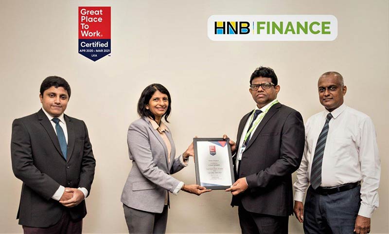HNB FINANCE Managing Director Chaminda Prabhath receiving the Great Place to Work certification.
