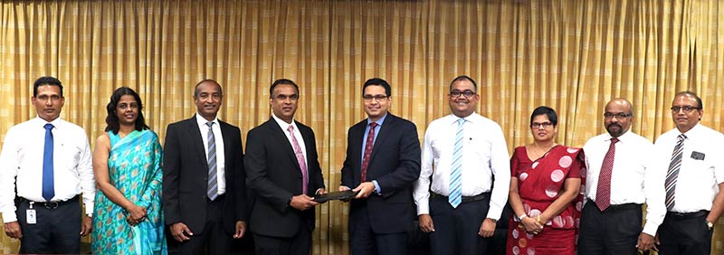 Commercial Bank’s Chief Operating Officer Mr Sanath Manatunge (centre) and Associated Motorways (Private) Ltd. Managing Director Mr Brandon Morris exchange the agreement in the presence of (from left) AMW Deputy General Manager – CNH Sales Mr Susantha Priyalal, Head of Legal  Ms Ruvini Weerasinghe, Director – Commercial Vehicles & Renault Mr Chaminda Perera; Commercial Bank’s Deputy General Manager – Marketing Mr Hasrath Munasinghe, Deputy General Manager – Personal Banking Ms Sandra Walgama, Senior Manager – Retail Products Department Mr Dushmantha Jayasuriya and Manager – Retail Products Department Mr Chandana Abeysundara.