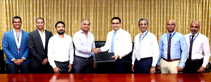 Commercial Bank’s Chief Operating Officer Mr Sanath Manatunge (4th from right) and Tenaga Car Parks (Pvt) Ltd. CEO/MD Mr Duminda Jayathilake exchange the agreement in the presence of (from left) Digital Payment Services (Pvt) Ltd. Director Mr Sanjiv Alles and CEO/MD Mr Mufaddal Lukmanjee, Tenaga Car Parks (Pvt) Ltd. Head of Business Development and Command Centre Operations Mr Dilshan N. Mathew and the Bank’s Head of Digital Banking Unit Mr Pradeep Banduwansa, Manager - Digital Banking Unit Mr Anush Gunarathne and Officer Digital Banking Unit Mr Nuwan Sudusinghe.