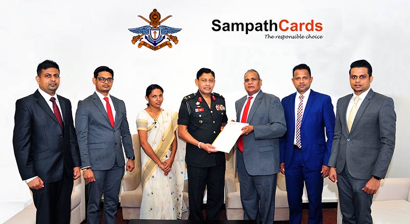 Kusal De Silva, Assistant General Manager - Operations & Card Centre, Sampath Bank (5th from left) handing over the agreement to Major General Milinda Peiris RWP RSP VSV VSP, Vice Chancellor of General Sir John Kotelawala Defence University.Others in the picture are (From left) – Prasanna De Silva – Senior Marketing Officer, Chaminda Samarajeewa, Assistant Manager -Sales & Merchant Relationships, Card Centre, Sampath Bank, AKD Imalie – Acting Bursar, KDU,  Darshin Pathinayake, Head of Card Centre, Sampath Bank and Chirath Samarasekara, Manager - Card Promotions, Loyalty & Product Strategy, Card Centre, Sampath Bank.