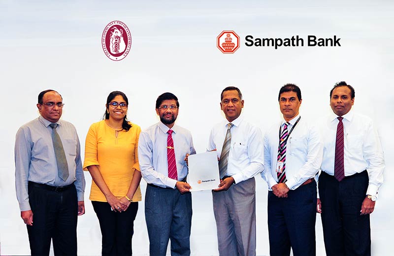 Nanda Fernando, Managing Director, Sampath Bank PLC (3rd from right) handing over the agreement to Dr. Nihal Abeysinghe, President-Elect, College of Community Physicians of Sri Lanka (CCPSL). The others in the picture are (from left) - Dr. Mahendra Arnold, Treasurer, CCPSL; Dr. Manuja Perera, Secretary, CCPSL; Tharaka Ranwala, Senior Deputy General Manager - Consumer Banking, Sampath Bank PLC and Deepal De Silva, Deputy General Manager - Branch Banking, Sampath Bank PLC.