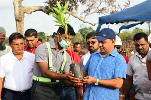Forestry Department presents the Hon. Minister of Environment Mahinda Amaraweera with a plant to symbolise the reforestation project.