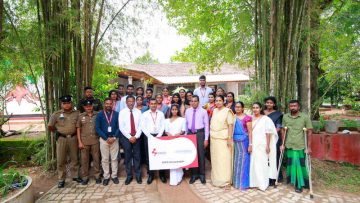 01 Image – D.N.D. Deraniyagala from Gampaha receiving the scholarship at the school with her family members and other representatives. She has been selected to the University of Colombo,