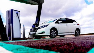 Electric,Car,Charging,Point,With,Nissan,Leaf,Connected.,Ev,Parking