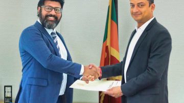 Hon.-Dilum-Amunugama-State-Minister-of-Ministry-of-Investment-Promotion-hands-Mr.-Sajeev-Rajaputhra-Chariman-of-Rajaputhra-Group-of-Companies-his-appointment-letter