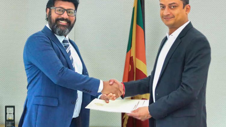 Hon.-Dilum-Amunugama-State-Minister-of-Ministry-of-Investment-Promotion-hands-Mr.-Sajeev-Rajaputhra-Chariman-of-Rajaputhra-Group-of-Companies-his-appointment-letter